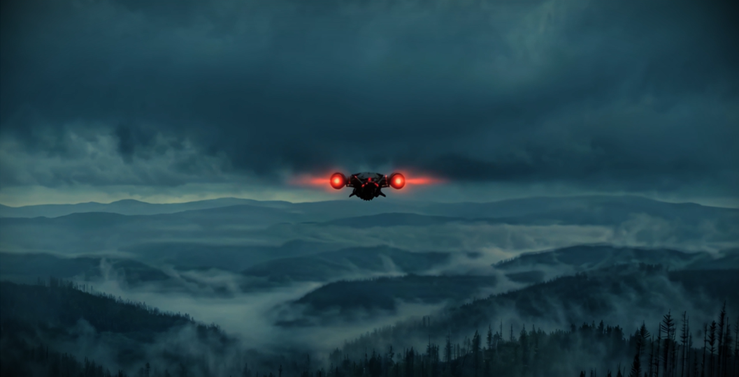 Aircraft crossing a fog-covered mountain landscape.