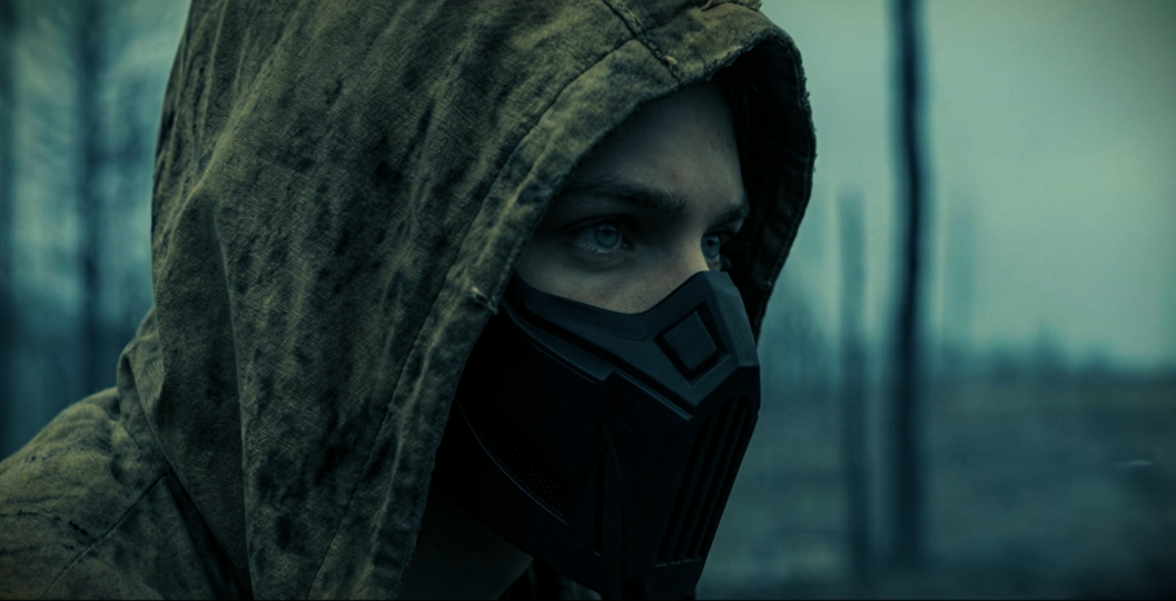 Masked survivor profile in the burnt forest.